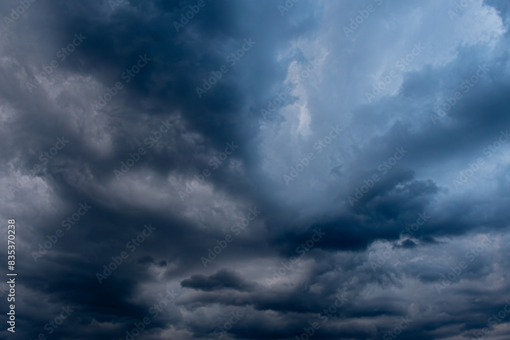 A captivating view of dark, swirling storm clouds filling the sky, creating a dramatic and moody atmosphere. The interplay of light and shadow highlights the intensity of the impending weather. A captivating view of dark, swirling storm clouds filling the sky, creating a dramatic and moody atmosphere. The interplay of light and shadow highlights the intensity of the impending weather.