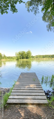 Vertical panoramic view of a pier and a lake