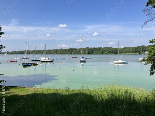 Pretty landscape showing a lake and some sailboats photo