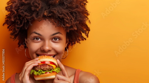 Woman Eating a Hamburger With a Smile