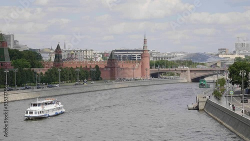 View of the Moscow Kremlin from the Moscow river. Red brick towers and Bell Tower Of Ivan The Great.