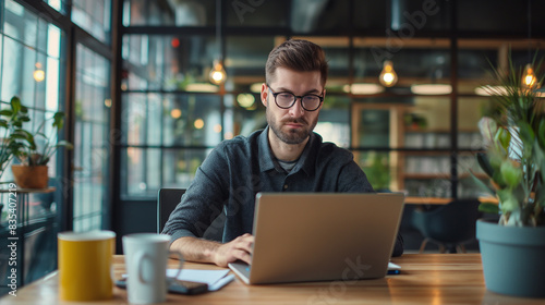 Young professional man working at modern desk