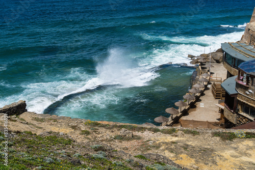 Azenhas do Mar is a seaside town in the municipality of Sintra, Portugal. Close to Lisboa. Azenhas do Mar white village, cliff and ocean. Sunny day.