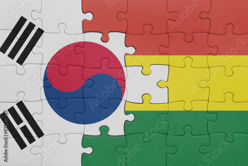 puzzle with the colourful national flag of bolivia and flag of south korea.