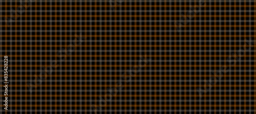 Orange and beige plaid fabric texture in the black background