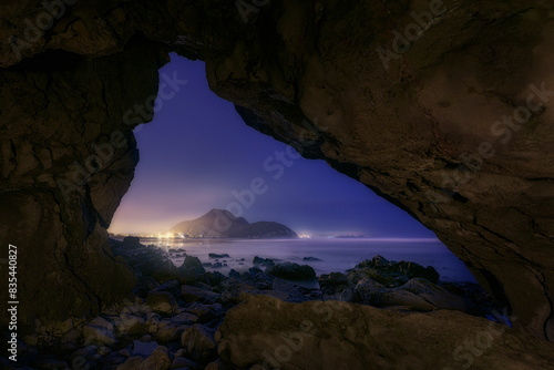 Night view from a natural cave on Berria beach, Cantabria