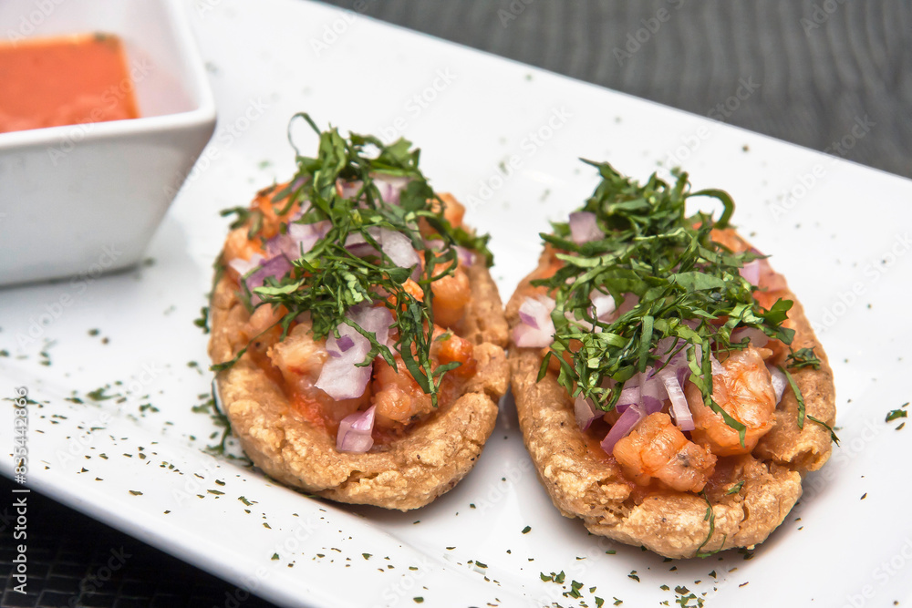 Mexican food, shrimp sopes with spicy sauce, cilantro and onion, Mexican craving for corn tortilla Mexican food, shrimp sopes with spicy sauce, cilantro and onion, Mexican craving for corn tortilla