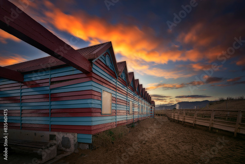 Colorful beach hut on La Arena beach in Muskiz on a nice sunrise with orange clouds photo