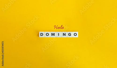 Hola Domingo (Hello Sunday) in Spanish Language. Text on Block Letter Tiles on Yellow Background. Minimal Aesthetics. photo