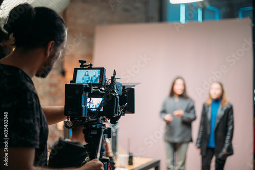 Director of photography with a camera in his hands on the set.  Filming process indoors, studio