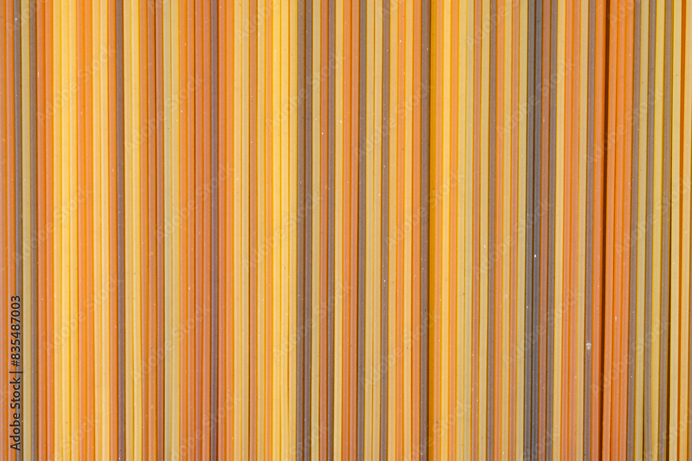 Fototapeta premium Food background, colorul dried pasta spaghetti, paralleled lines, wallpapers with stripes