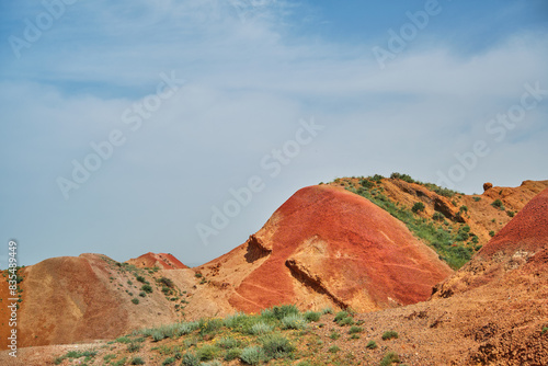 Vibrant red mountains in spring contrasting with the blue spring sky. The unique landscape and expansive views create a visually breathtaking landscape of Kvemo Kartli. photo