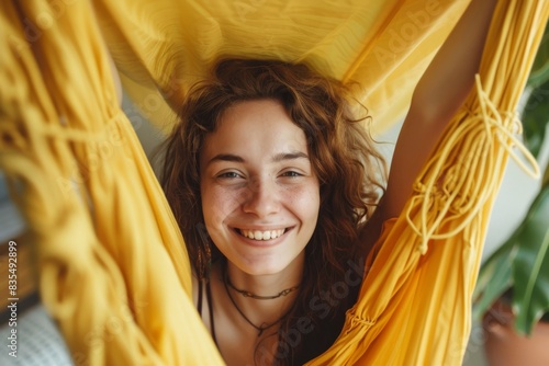 An apartment dweller relaxes in a hammock while smiling photo