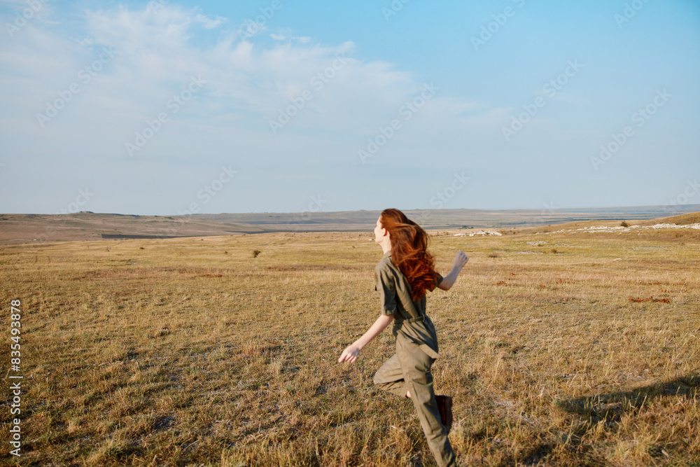 Woman running through grassy field on sunny day in nature beauty adventure travel concept Woman running through grassy field on sunny day in nature beauty adventure travel concept