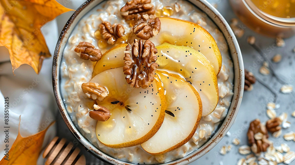 Close-up of a bowl of oatmeal topped with sliced pear, walnuts, and honey, highlighting a nutritious and delicious breakfast. Close-up of a bowl of oatmeal topped with sliced pear, walnuts, and honey, highlighting a nutritious and delicious breakfast.
