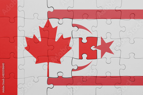 puzzle with the colourful national flag of northern cyprus and flag of canada.