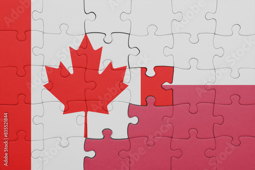 puzzle with the colourful national flag of poland and flag of canada.