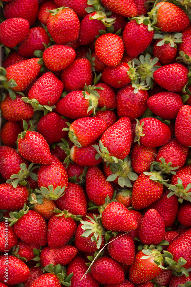 A wooden crate brimming with fresh, ripe strawberries, bursting with vibrant red color and juicy sweetness, ready to eat A wooden crate brimming with fresh, ripe strawberries, bursting with vibrant red color and juicy sweetness, ready to eat