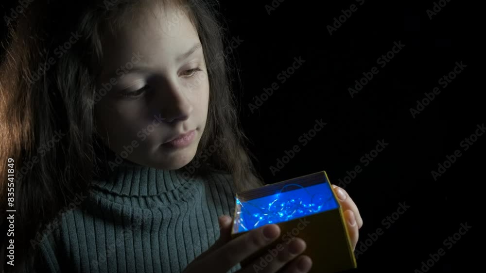 Child amazing mood with garland. A view of little girl hold box with garland and enjoy the amazing weekend time. Child amazing mood with garland. A view of little girl hold box with garland and enjoy the amazing weekend time.