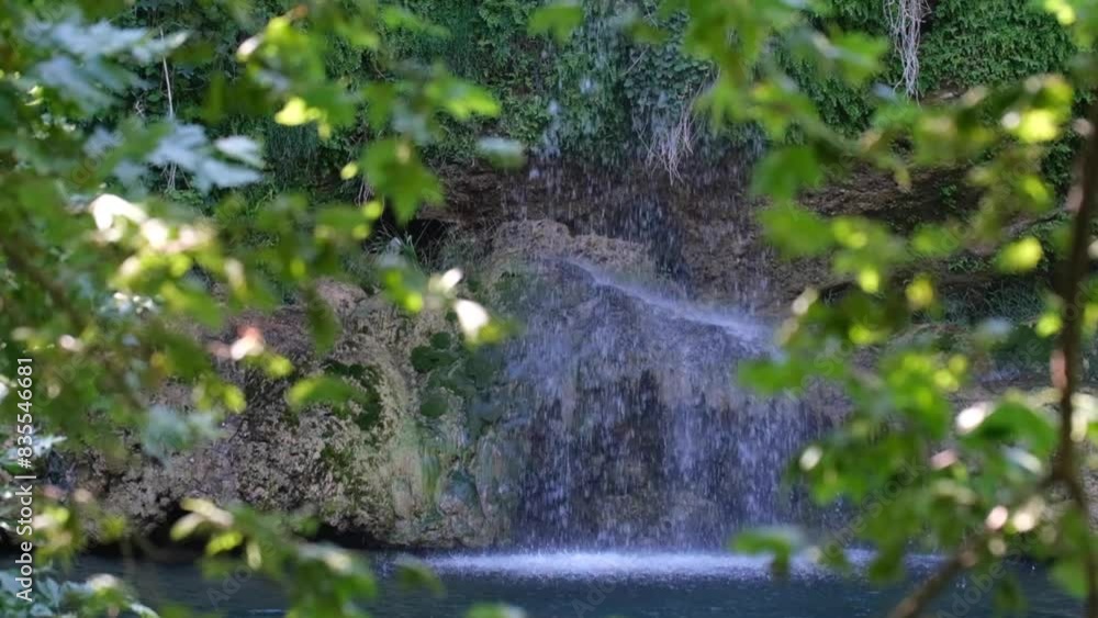 Slow motion waterfall in greenery Slow motion waterfall in greenery