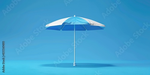 A blue and white umbrella sits on a blue surface, ready for use