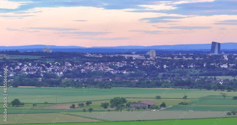 Drone flyby of the Frankfurt skyline in front of a colorful evening sky with light clouds Drone flyby of the Frankfurt skyline in front of a colorful evening sky with light clouds