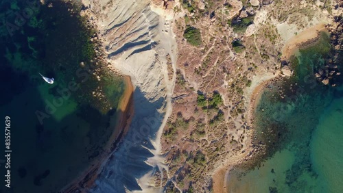 Qarraba Bay flat rock cape Malta, Aerial circular or orbiting shot in the morning sunlight. High quality 4k footage photo