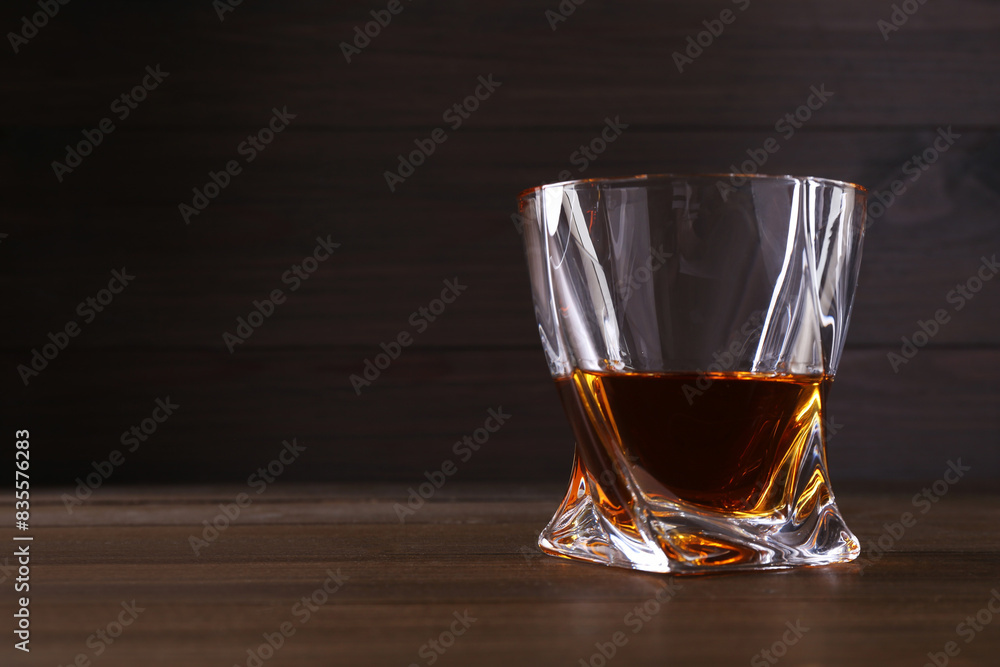 Delicious liqueur in glass on wooden table. Space for text Delicious liqueur in glass on wooden table. Space for text