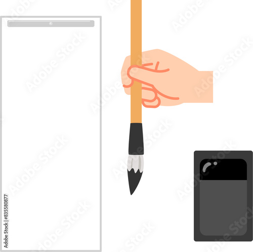 毛筆を持った手と硯と半紙