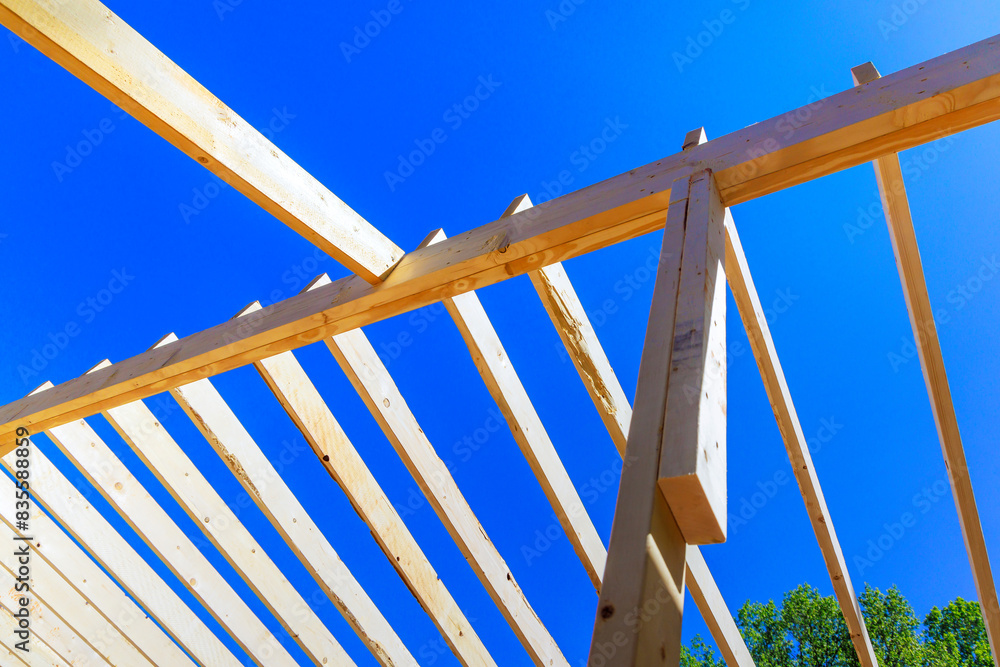 Building new house construction improvement consists of installing framing beams, wooden trusses Building new house construction improvement consists of installing framing beams, wooden trusses