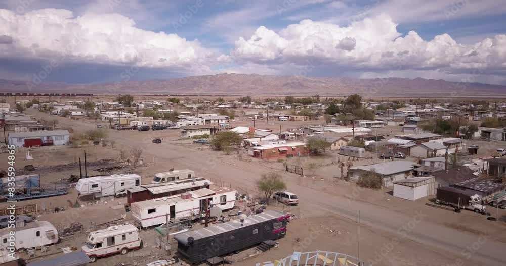 Flying over buildings in Bombay Beach with a train in the distance. Flying over buildings in Bombay Beach with a train in the distance.