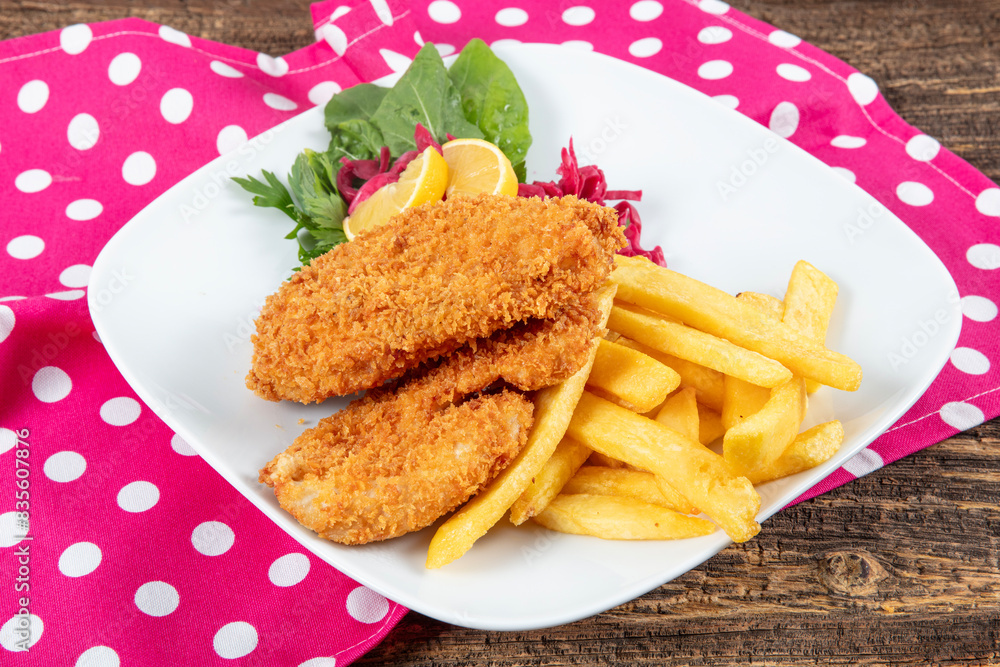 Fried Chicken schnitzel cordon bleu with cheese in breadcrumbs, restaurant food. Delicious tender chicken chnitzel with homemade french-fries Fried Chicken schnitzel cordon bleu with cheese in breadcrumbs, restaurant food. Delicious tender chicken chnitzel with homemade french-fries