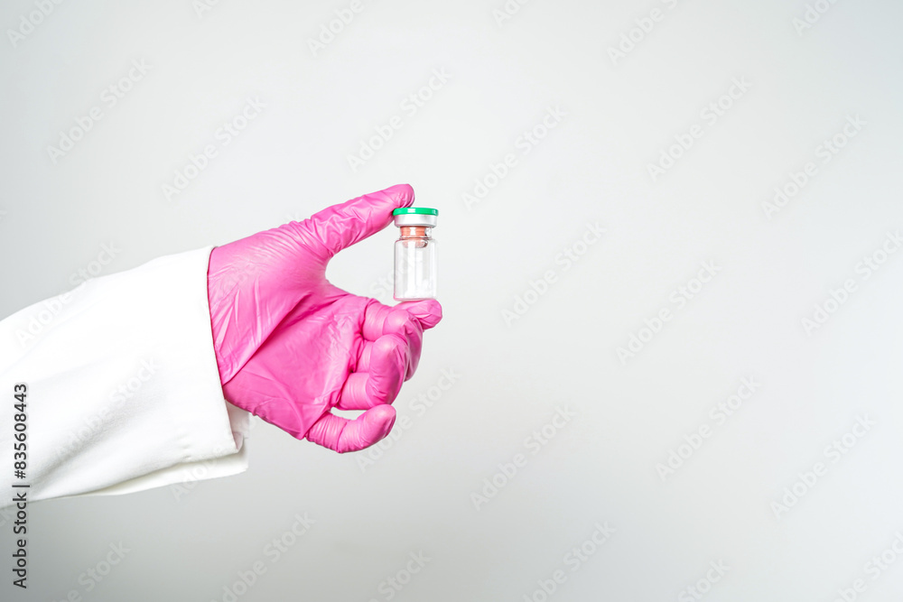 virus vaccine bottle for injection in hand of doctor or Technician scientist virus vaccine bottle for injection in hand of doctor or Technician scientist