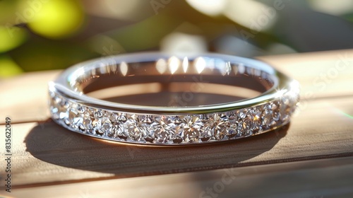 White gold wedding band with sparkling diamond accents, showcased in a close-up shot, beautifully lit to enhance its brilliance photo