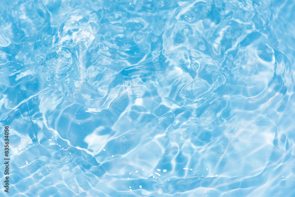 Blue water with ripples on the surface. Defocus blurred transparent blue colored clear calm water surface texture with splashes and bubbles. Water waves with shining pattern texture background. Blue water with ripples on the surface. Defocus blurred transparent blue colored clear calm water surface texture with splashes and bubbles. Water waves with shining pattern texture background.