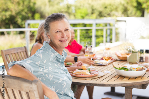 Diverse senior female friends sharing meal outdoors