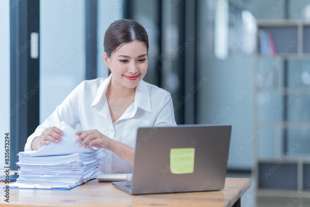 The Asian female business professional displayed a cheerful expression in her office. The Asian female business professional displayed a cheerful expression in her office.