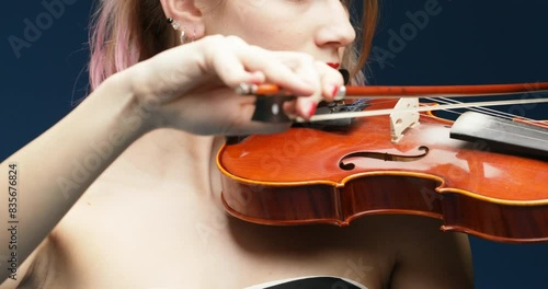 Fuchsia hair, black dress, blue background violin