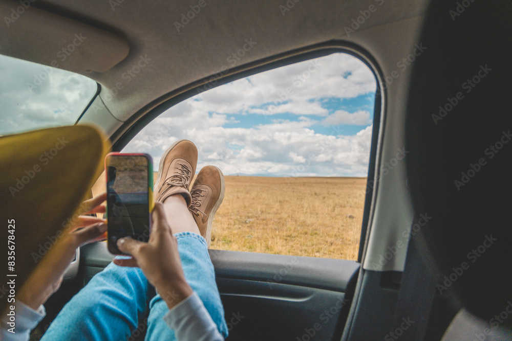 A person is laying in a car with their feet up and looking at their phone. Huayllay Stone Forest, Peru. A person is laying in a car with their feet up and looking at their phone. Huayllay Stone Forest, Peru.