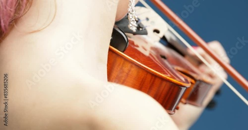 Bare shoulders, intense music play, backdrop blue