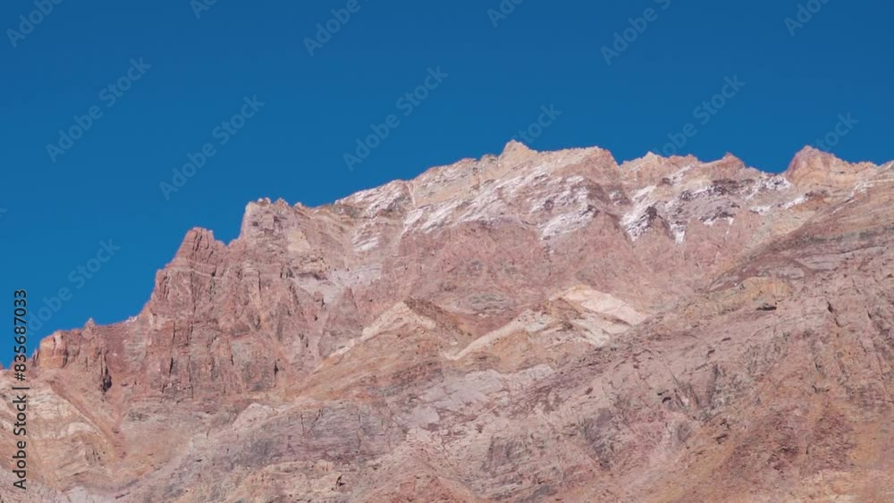 Rocky mountain cliffs against the blue sky at Zanskar valley seen on the way towards Phugtal Monastery near Purne in Ladakh, India. Rocky structures on the side of the mountains in the Himalayas. Rocky mountain cliffs against the blue sky at Zanskar valley seen on the way towards Phugtal Monastery near Purne in Ladakh, India. Rocky structures on the side of the mountains in the Himalayas.