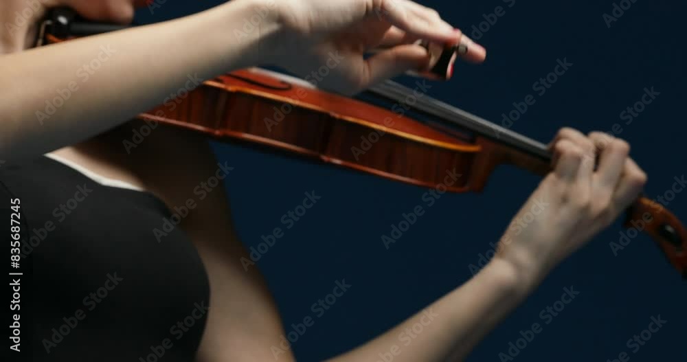 Pink-haired musician focuses, violin sings clearly