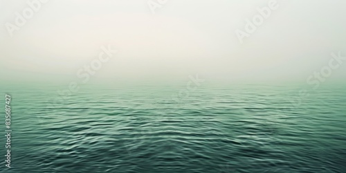 Vast expanse of calm ocean beneath a moody, cloud-filled sky. Atmospheric nature scene concept.