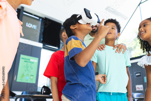 In school, diverse group of young students are exploring virtual reality photo