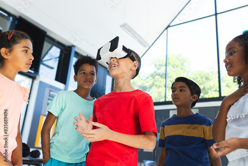 In school, group of biracial young students are exploring virtual reality