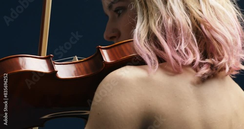 Fuchsia hair, black dress, blue background violin