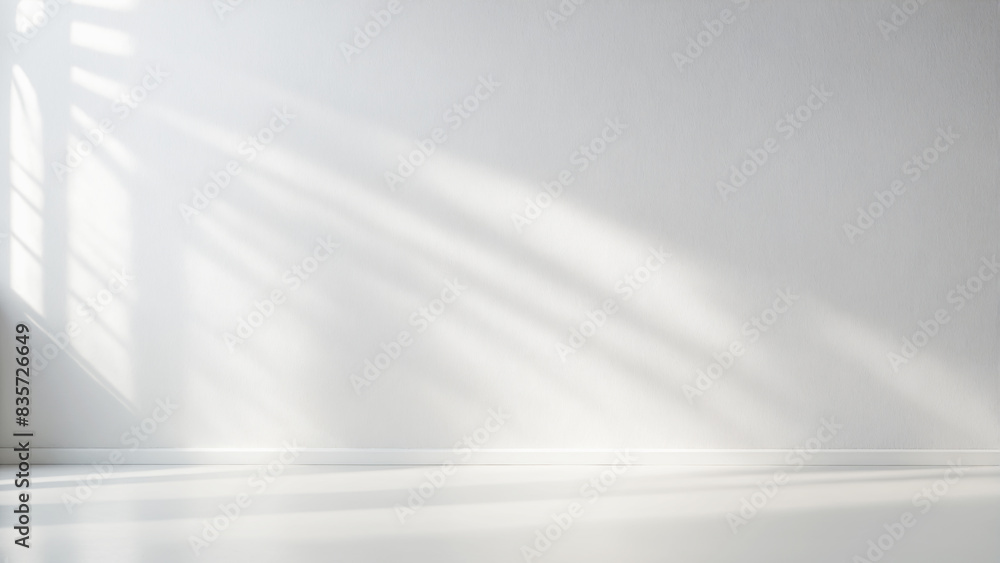 Minimalistic light background with blurred foliage shadow on white wall Minimalistic light background with blurred foliage shadow on white wall
