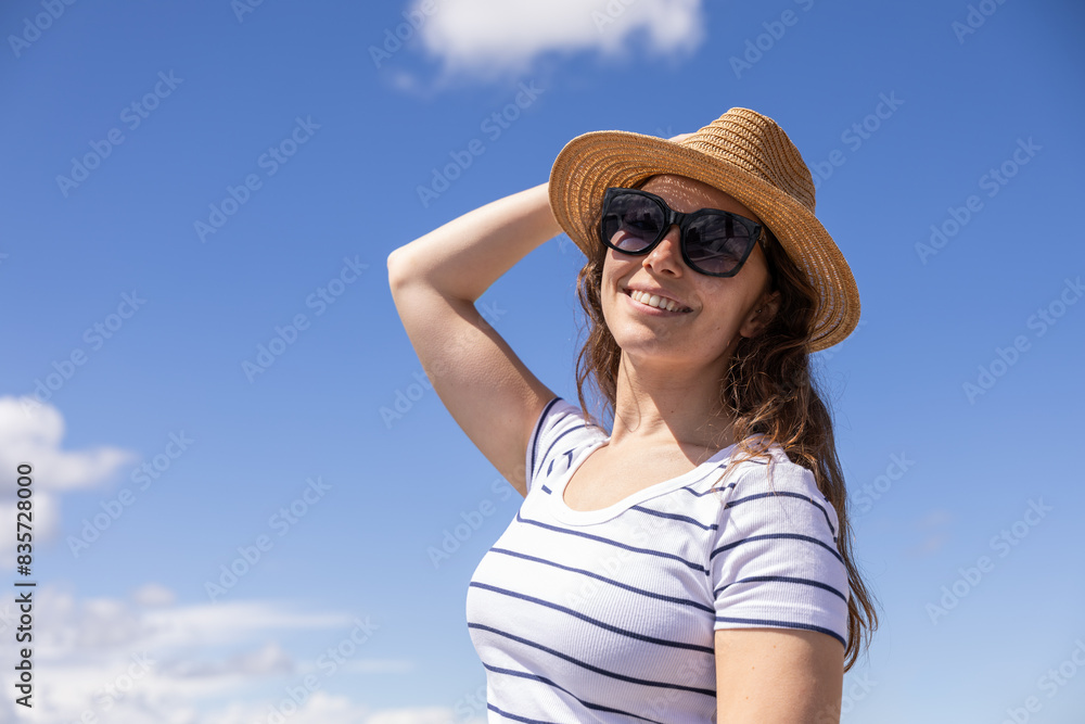 young woman puts on sunscreen to protect herself from the sun on a hot day young woman puts on sunscreen to protect herself from the sun on a hot day