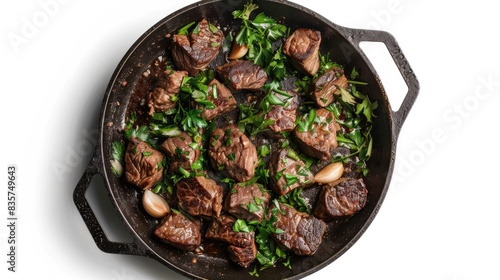 Beef cooked in a skillet with garlic viewed from above on a white background photo