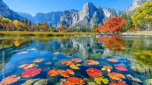  A tranquil lake nestled among mountains and forest, its surface dotted with drifting leaves In the foreground, a modest mountain range cradles sparse trees and avian photo